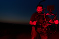 Nighttime Capture: Professional Videographer Films Athletes Running in Red-Lit Darkness - PhotoDune Item for Sale