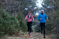 trail running with a sporty couple in the magic forest in early morning - PhotoDune Item for Sale