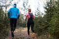 trail running with a sporty couple in the magic forest in early morning - PhotoDune Item for Sale