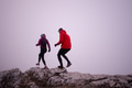 Athlete couple trail running on the mountain top in the early morning. Sky running concept - PhotoDune Item for Sale