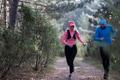 trail running with a sporty couple in the magic forest in early morning - PhotoDune Item for Sale