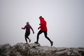 Athlete couple trail running on the mountain top in the early morning. Sky running concept - PhotoDune Item for Sale