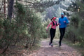 trail running with a sporty couple in the magic forest in early morning - PhotoDune Item for Sale
