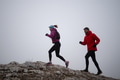 Athlete couple trail running on the mountain top in the early morning. Sky running concept - PhotoDune Item for Sale