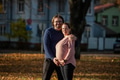 A man lovingly embraces his pregnant wife in the park, sharing a peaceful moment of warmth and - PhotoDune Item for Sale