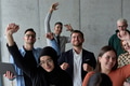 A diverse team of business professionals ecstatically celebrating their success in a modern office - PhotoDune Item for Sale