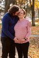 A man lovingly embraces his pregnant wife in the park, sharing a peaceful moment of warmth and - PhotoDune Item for Sale