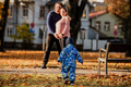 On a sunny autumn day in the park, a mother and father lovingly embrace their young son, sharing - PhotoDune Item for Sale