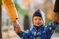 Parents walking hand in hand with their son through the charming city streets, enjoying the warmth - PhotoDune Item for Sale