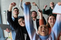 A diverse team of business professionals ecstatically celebrating their success in a modern office - PhotoDune Item for Sale