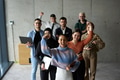 A diverse team of business professionals ecstatically celebrating their success in a modern office - PhotoDune Item for Sale