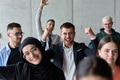 A diverse team of business professionals ecstatically celebrating their success in a modern office - PhotoDune Item for Sale
