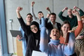 A diverse team of business professionals ecstatically celebrating their success in a modern office - PhotoDune Item for Sale