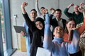 A diverse team of business professionals ecstatically celebrating their success in a modern office - PhotoDune Item for Sale