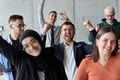 A diverse team of business professionals ecstatically celebrating their success in a modern office - PhotoDune Item for Sale
