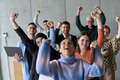 A diverse team of business professionals ecstatically celebrating their success in a modern office - PhotoDune Item for Sale