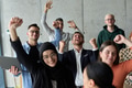 A diverse team of business professionals ecstatically celebrating their success in a modern office - PhotoDune Item for Sale