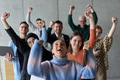 A diverse team of business professionals ecstatically celebrating their success in a modern office - PhotoDune Item for Sale