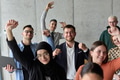 A diverse team of business professionals ecstatically celebrating their success in a modern office - PhotoDune Item for Sale