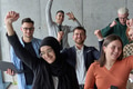 A diverse team of business professionals ecstatically celebrating their success in a modern office - PhotoDune Item for Sale