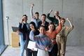 A diverse team of business professionals ecstatically celebrating their success in a modern office - PhotoDune Item for Sale