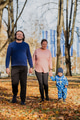 A loving couple strolls through a sunlit park with their young son, surrounded by the vibrant colors - PhotoDune Item for Sale