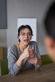 A close up portrait of a young businesswoman engaged in a professional meeting, confidently - PhotoDune Item for Sale
