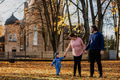A loving couple strolls through a sunlit park with their young son, surrounded by the vibrant colors - PhotoDune Item for Sale
