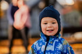 A joyful little boy in his winter coat and hat plays happily in the park, surrounded by the love and - PhotoDune Item for Sale