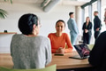 A diverse team of business professionals engaged in a discussion around a conference table in an - PhotoDune Item for Sale