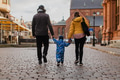 Parents walking hand in hand with their son through the charming city streets, enjoying the warmth - PhotoDune Item for Sale