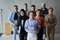 A diverse and determined team of business professionals stands confidently in an office, ready to - PhotoDune Item for Sale