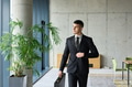 A determined businessman in a black suit confidently walks through the office, embodying - PhotoDune Item for Sale