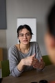 A close up portrait of a young businesswoman engaged in a professional meeting, confidently - PhotoDune Item for Sale