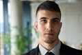 A close up portrait of a company director in a black suit, standing confidently in a modern office - PhotoDune Item for Sale