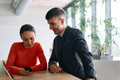 A young, diverse business team sitting together in a modern office, exchanging ideas and business - PhotoDune Item for Sale