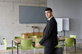 A determined businessman in a black suit confidently walks through the office, embodying - PhotoDune Item for Sale