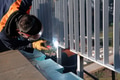 Industrial welder skillfully crafts a metal fence for a new business complex, using modern equipment - PhotoDune Item for Sale