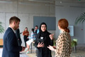A diverse group of business professionals engages in a conversation during a work break in the - PhotoDune Item for Sale