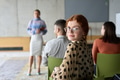 A diverse group of business professionals sits attentively in a modern office, actively - PhotoDune Item for Sale
