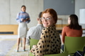A diverse group of business professionals sits attentively in a modern office, actively - PhotoDune Item for Sale
