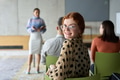 A diverse group of business professionals sits attentively in a modern office, actively - PhotoDune Item for Sale