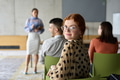 A diverse group of business professionals sits attentively in a modern office, actively - PhotoDune Item for Sale