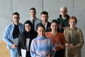 A diverse and determined team of business professionals stands confidently in an office, ready to - PhotoDune Item for Sale