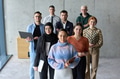 A diverse and determined team of business professionals stands confidently in an office, ready to - PhotoDune Item for Sale