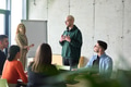 A young, diverse business team sitting together in a modern office, exchanging ideas and business - PhotoDune Item for Sale