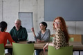 A young, diverse business team sitting together in a modern office, exchanging ideas and business - PhotoDune Item for Sale