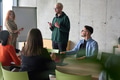 A young, diverse business team sitting together in a modern office, exchanging ideas and business - PhotoDune Item for Sale