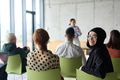 A diverse group of business professionals sits attentively in a modern office, actively - PhotoDune Item for Sale