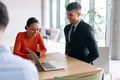 A young, diverse business team sitting together in a modern office, exchanging ideas and business - PhotoDune Item for Sale